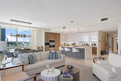 Open concept oceanfront living, dining, and kitchen area with luxury finishes and view of Singer Island beach